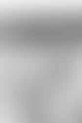 Candid engagement photos at Frenchman’s Bay beach with couple walking along the shoreline at golden hour