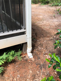 New PVC downspout connection to route water away from the home