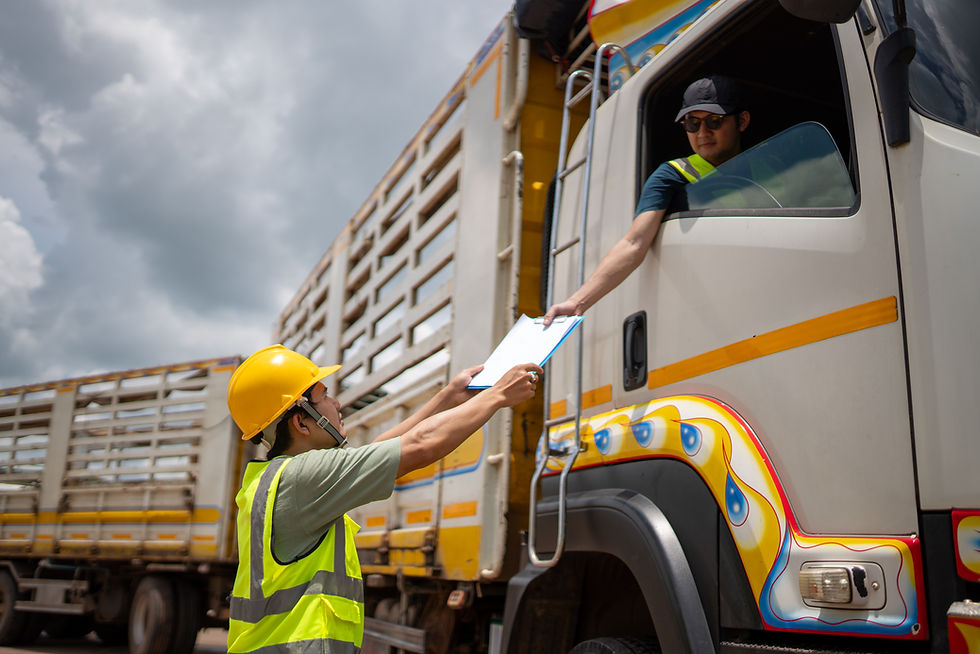 Logistics worker handing a clipboard to a truck driver
