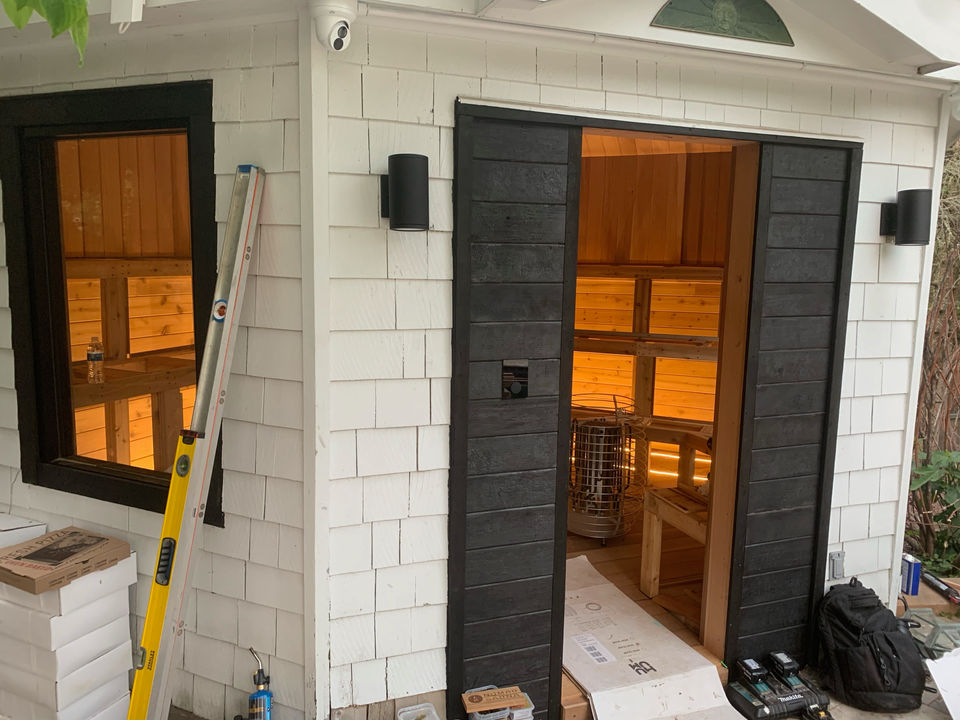 White shingled sauna with interior lights