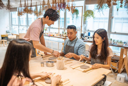 Group of people taking a Pottery class