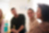 friendly woman talking to group in mental health therapy session.jpg