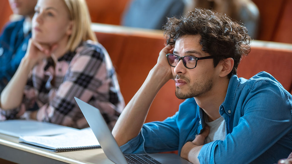 A young man looking bored in class