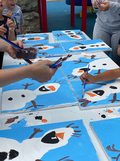The image displays children painting snowmen in a Palettes by Post – instructor-led art class.