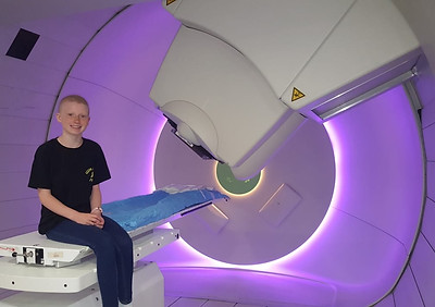Sally sat on an MRI scanner