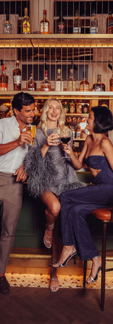 People at The Spaniel bar smiling and cheering in a warm lifestyle moment vibe