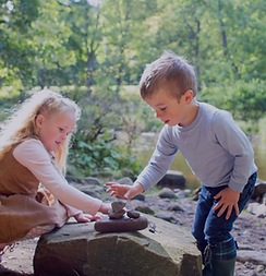 Forest Box_Children stacking rocks.png