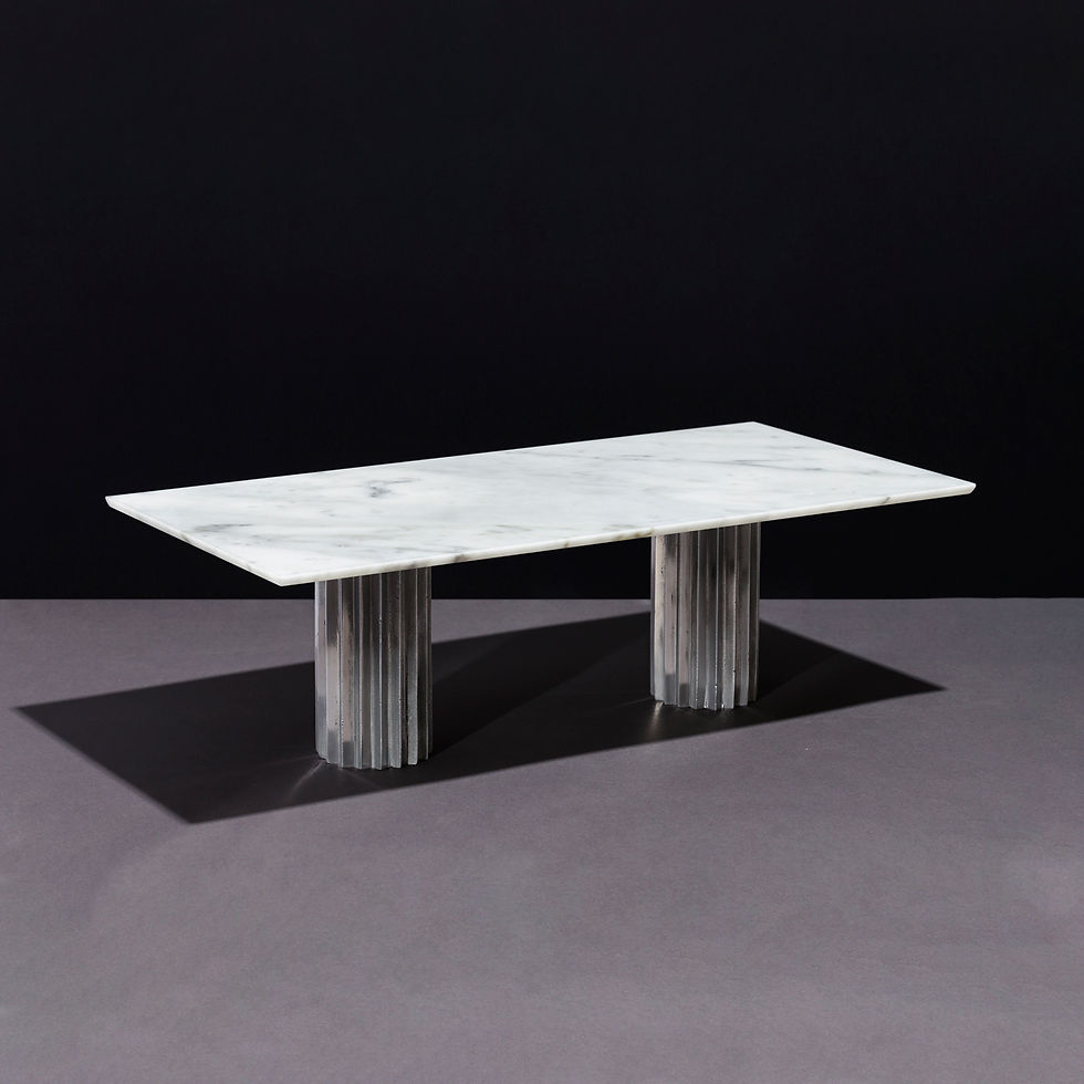 Sculptural dining table with double cast aluminum Doric pedestals and rectangular white Carrara stone top.