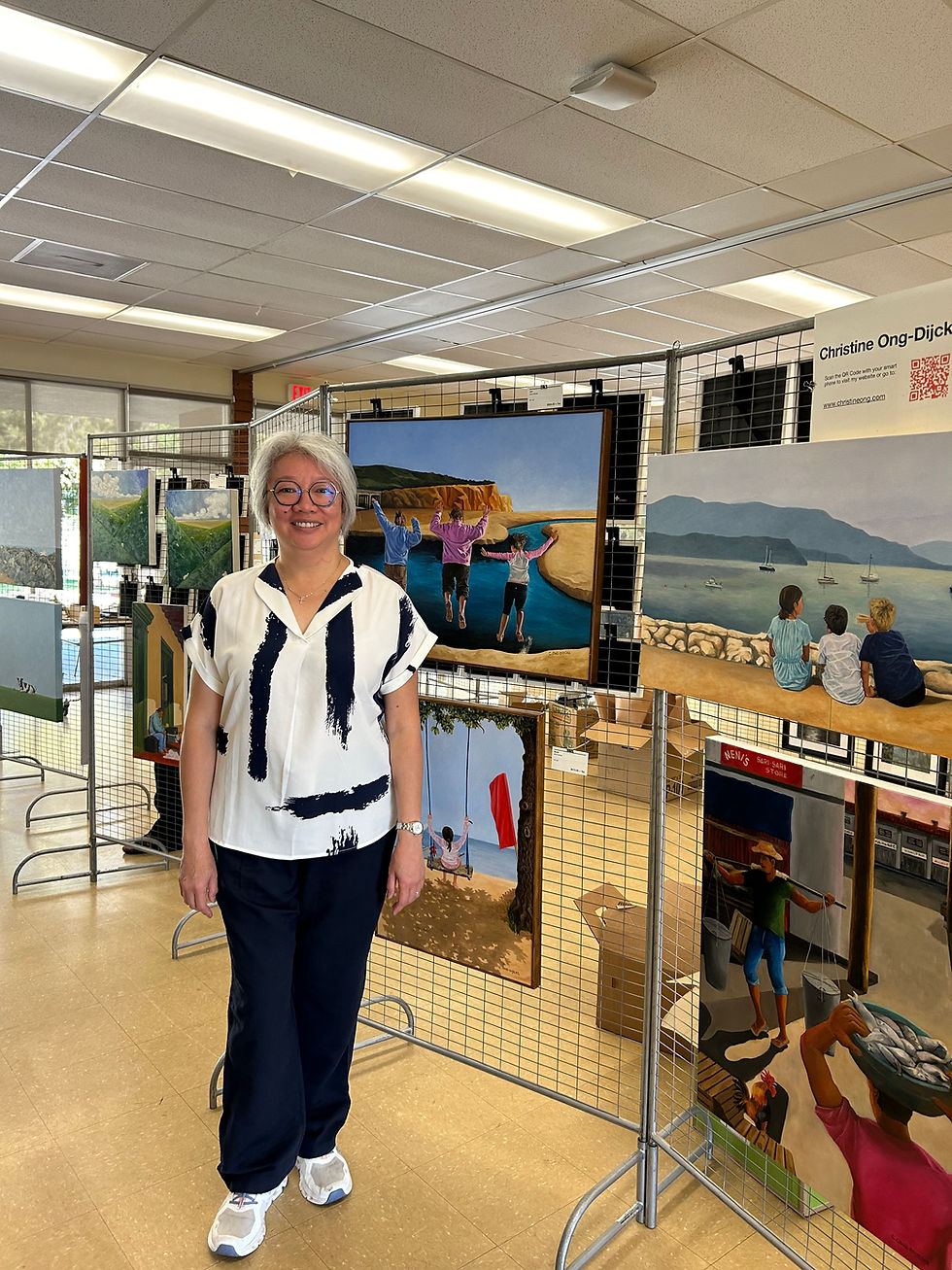 Artist posing in front of a set of colorful art pieces