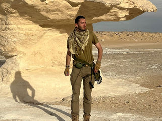 Explorer Dante Vonkayser walking through the vast Mongolian desert in expedition gear, embodying authentic cultural and adventure travel with Terra Firma Journeys.