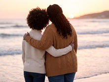 two people hugging on a beach