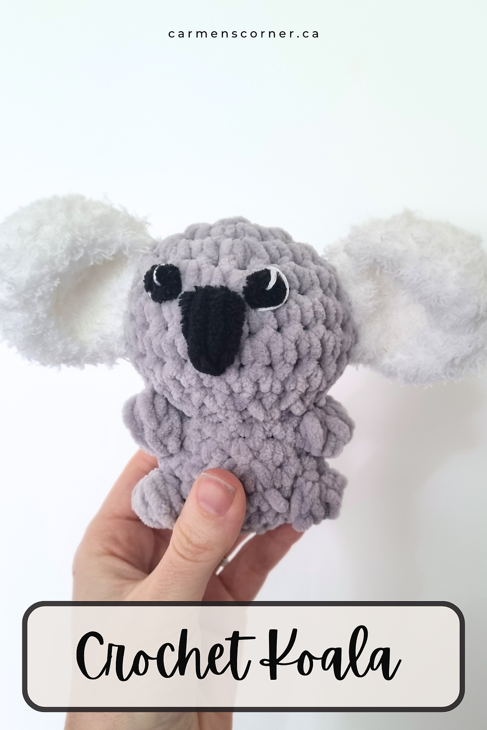 Hand holding a gray crochet koala with white fluffy ears. Text "Crochet Koala" and "carmenscorner.ca" visible. White background.