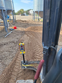 Heavy equipment view of ground leveling with laser level