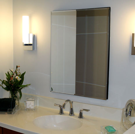 single sink bathroom vanity with lights to the left and right of mirror
