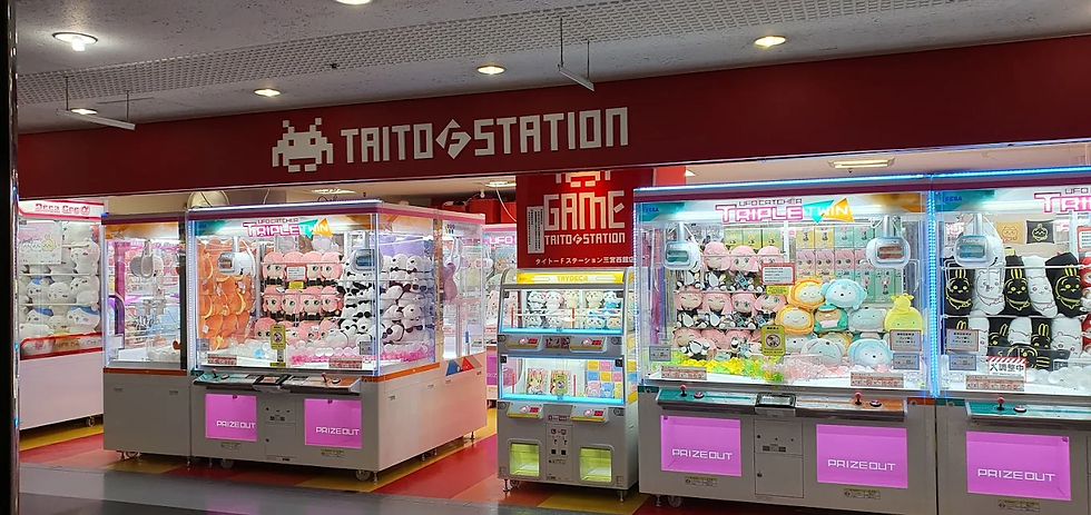 Neon-lit retro arcade in Motomachi, Kobe, near Sannomiya Station—filled with claw machines, classic games like Street Fighter, and a mix of locals and visitors enjoying nostalgic gaming culture and nightlife after shopping or dining near Tor Road and Chinatown.