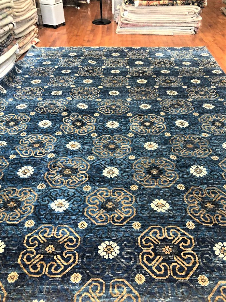 hand-woven Indian Tribal Rug, measuring 10'2" x 13'9". Crafted from a luxurious blend of wool and cotton,