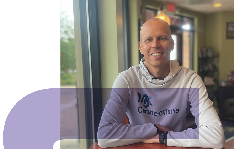 Matt Kemblowski, MJK Connections Founder, in an MJK Connections hoodie sitting indoors.