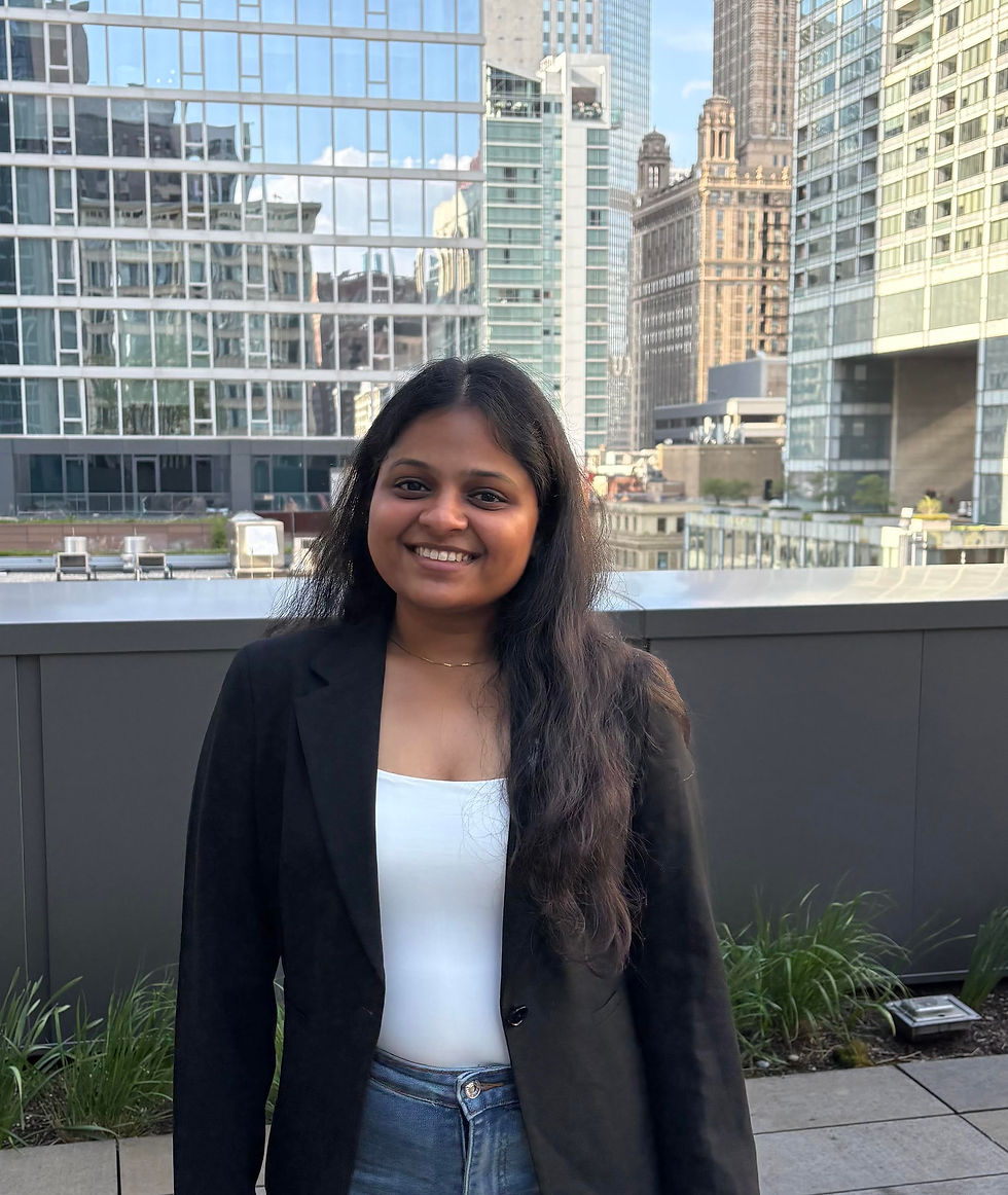 Smiling woman in a black blazer with a city skyline background