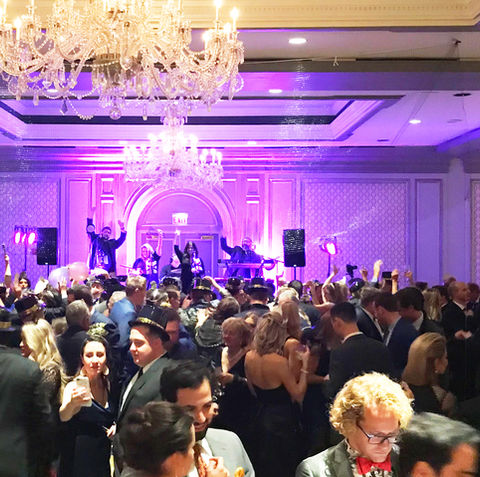A beautiful ballroom filled with people celebrating a new years eve wedding