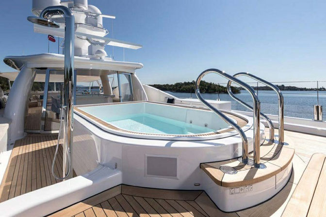 Jacuzzi pool with sun loungers on deck of Amigos yacht
