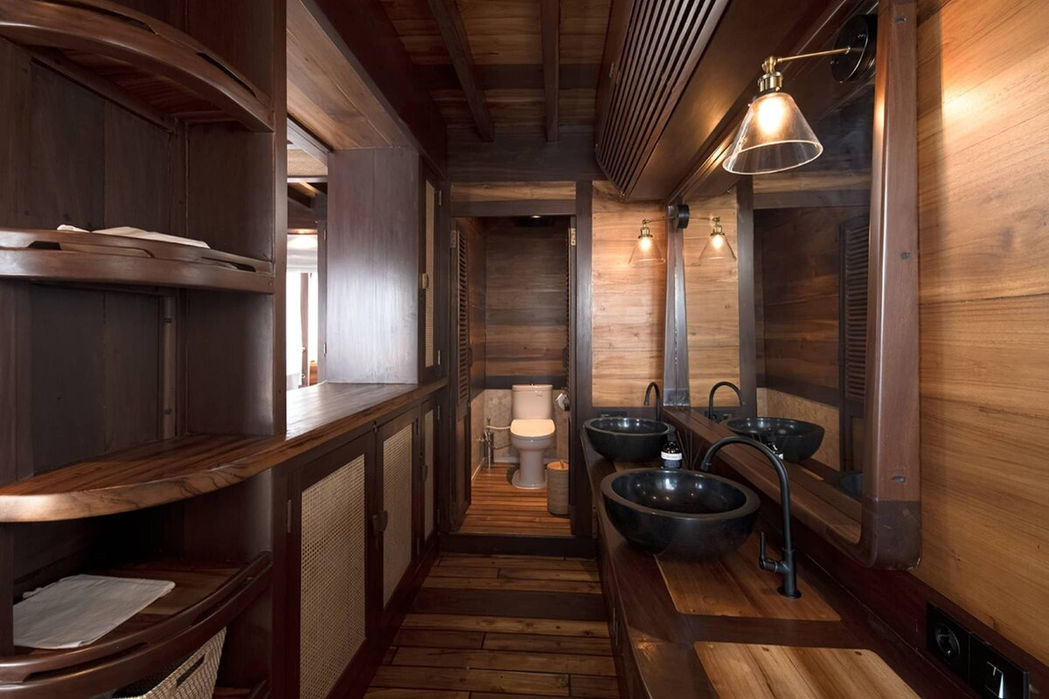 Indoor dining area with wooden furniture aboard Sanya yacht