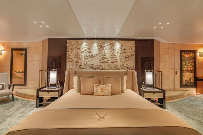 Master suite bedroom on a luxury yacht with king-size bed and modern decor