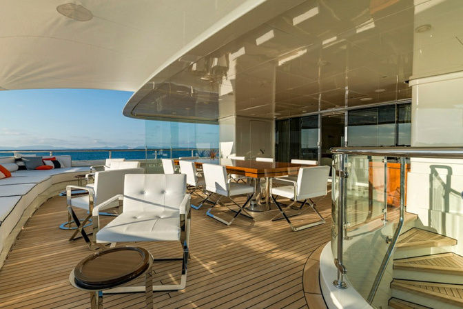 Modern yacht balcony with glass railing and ocean backdrop