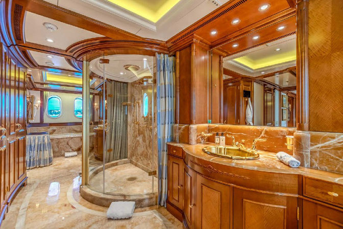 Opulent bathroom with gold fixtures inside yacht cabin