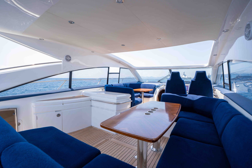Upper deck with dining setup on yacht