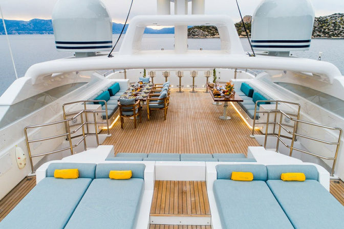 Expansive sundeck with loungers and parasols onboard private yacht