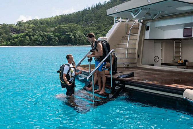 Guests enjoying water toys and swimming off Amigos yacht stern