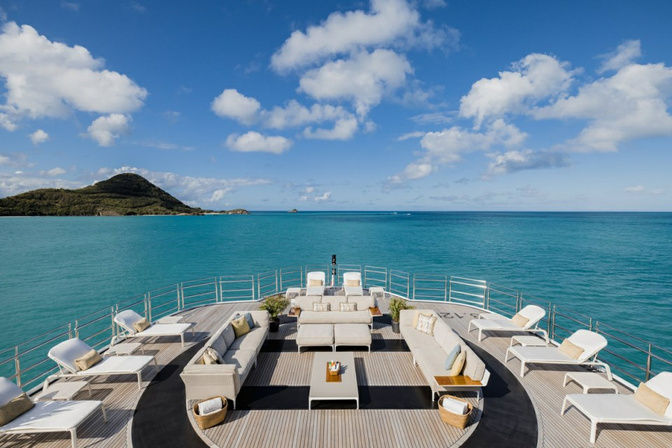 Expansive sundeck with loungers and jacuzzi on luxury yacht rental