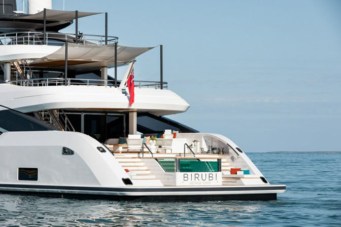 Wide swim platform with loungers and direct sea access on Birubi superyacht