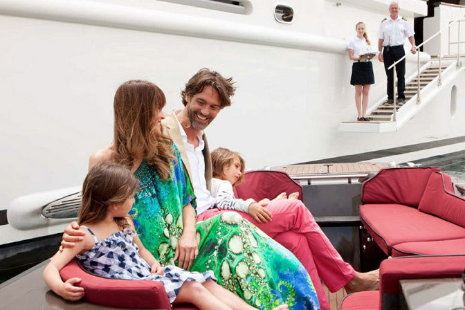 Family enjoying time together inside luxury yacht cabin