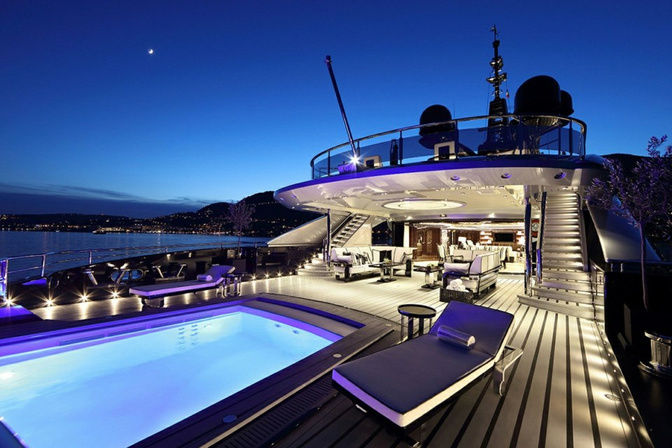 Evening view of luxury yacht deck with pool and lighting