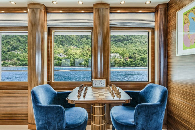 Dining nook with round table and plush seating onboard yacht