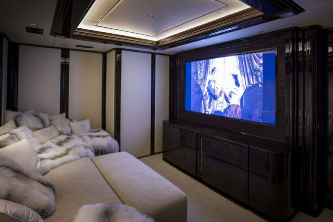 Yacht cinema room with large screen and plush seating
