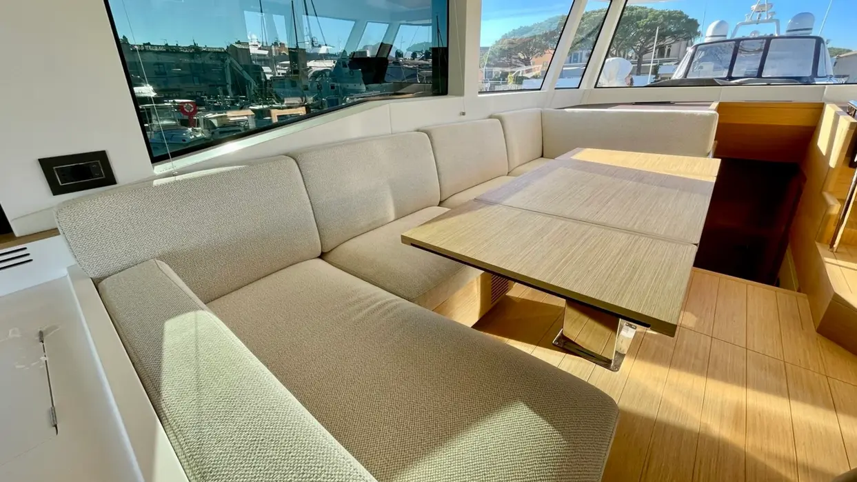 Salon of luxury yacht with comfortable seating and large windows