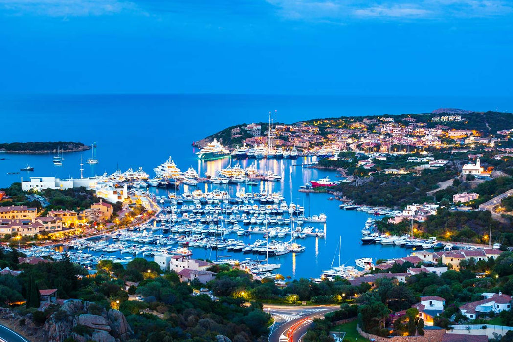 Panoramic aerial view of Porto Cervo marina with yachts and turquoise waters in Costa Smeralda, Sardinia.
