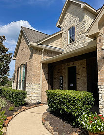 Professional gutter installers working on Houston home