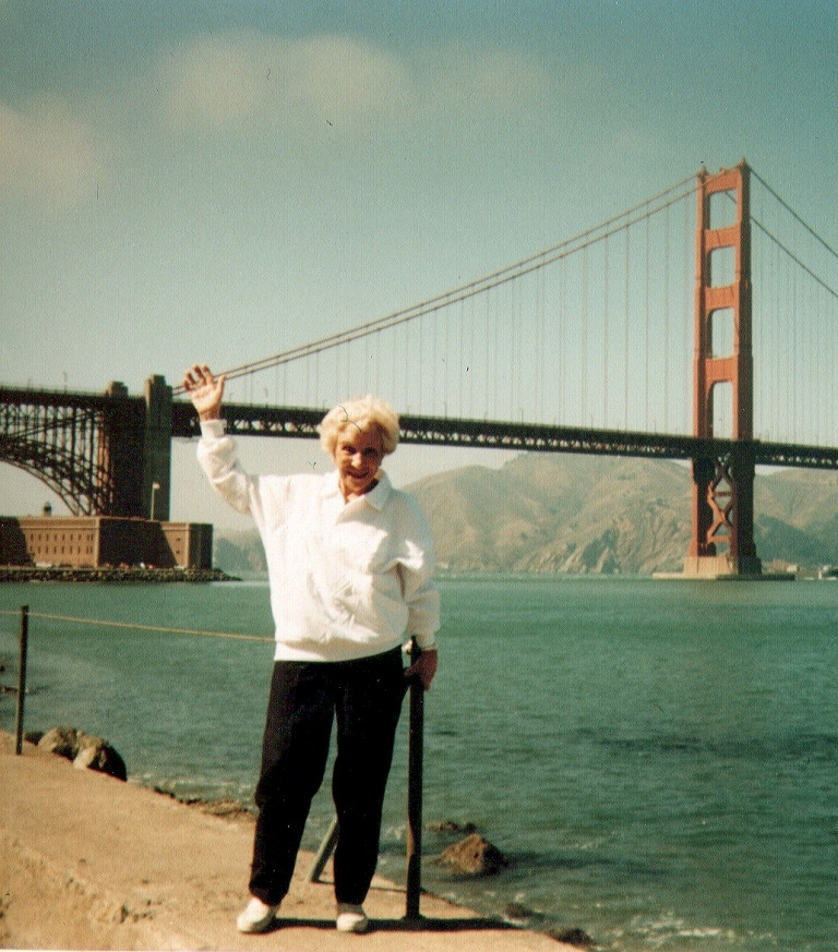 Helen Marquis waving at the Golden Gate Bridge