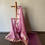 Thumbnail: pink colored banarasi plain tissue saree draped on a saree stand