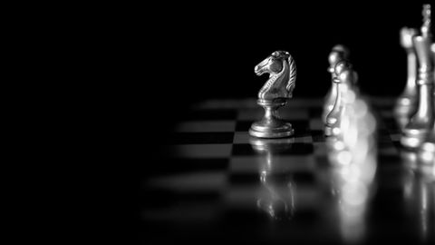 game of chess with knight slightly ahead