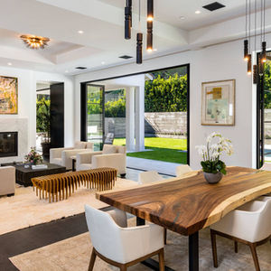 a living room with a large wooden table and chairs