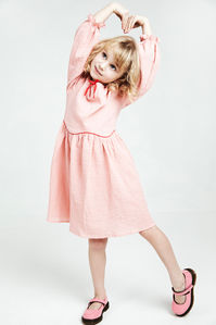 posing little model girl with pink dress