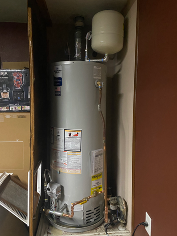 Bradford White tank water heater with expansion tank installed in a closet