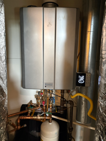 tankless water heater installed with copper piping and expansion tank