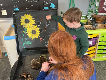 Young person helping child and blackboard