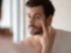 Men applying moisturizer