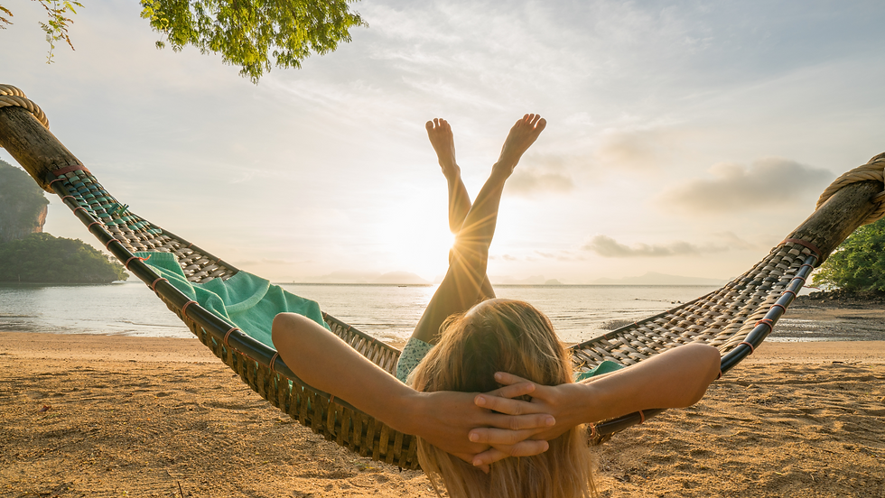 woman relaxing on a beach in a hammock